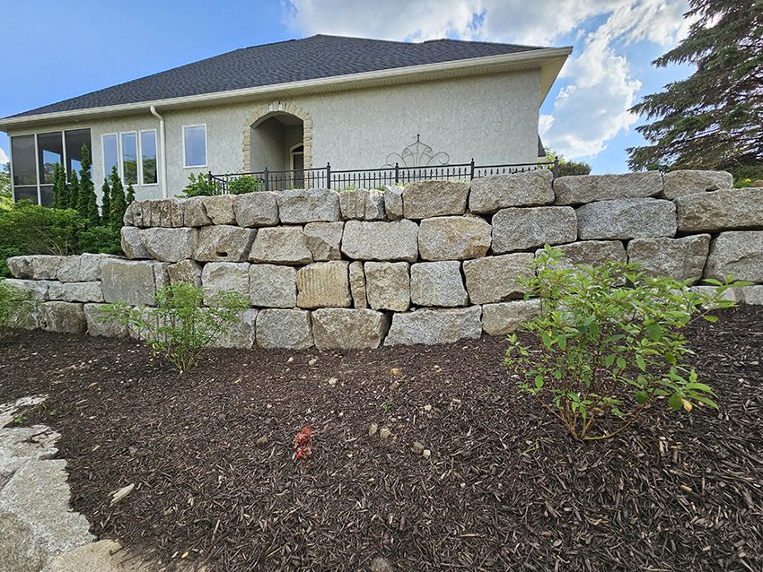 Residential Granite Boulder Retaining Wall Along A Landscape | Granite Companies MN