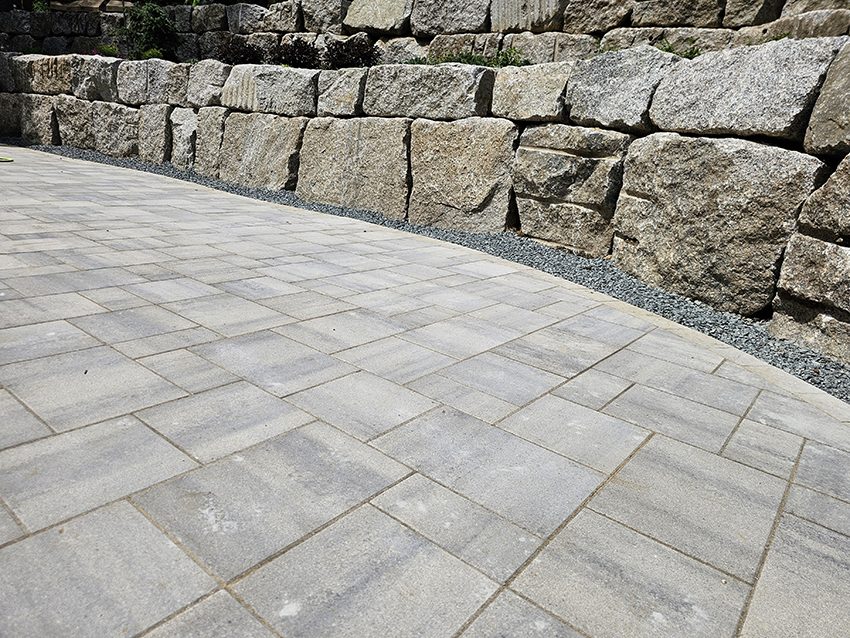 Residential Paver Patio Along A Granite Boulder Afterretaini | Granite Companies MN